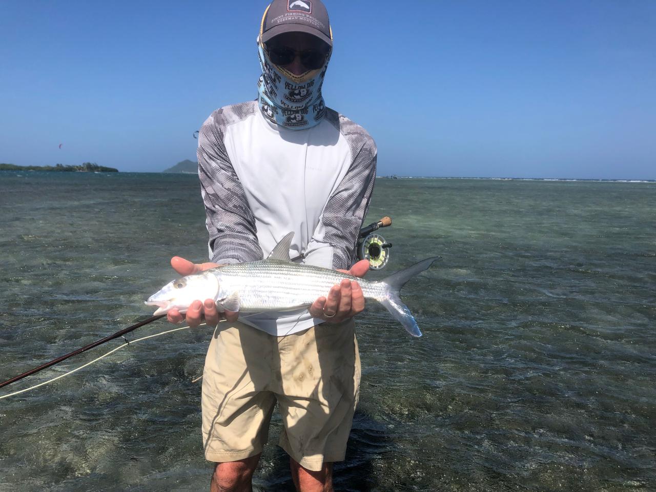 Guest holding a fish after a Roatan flats trip