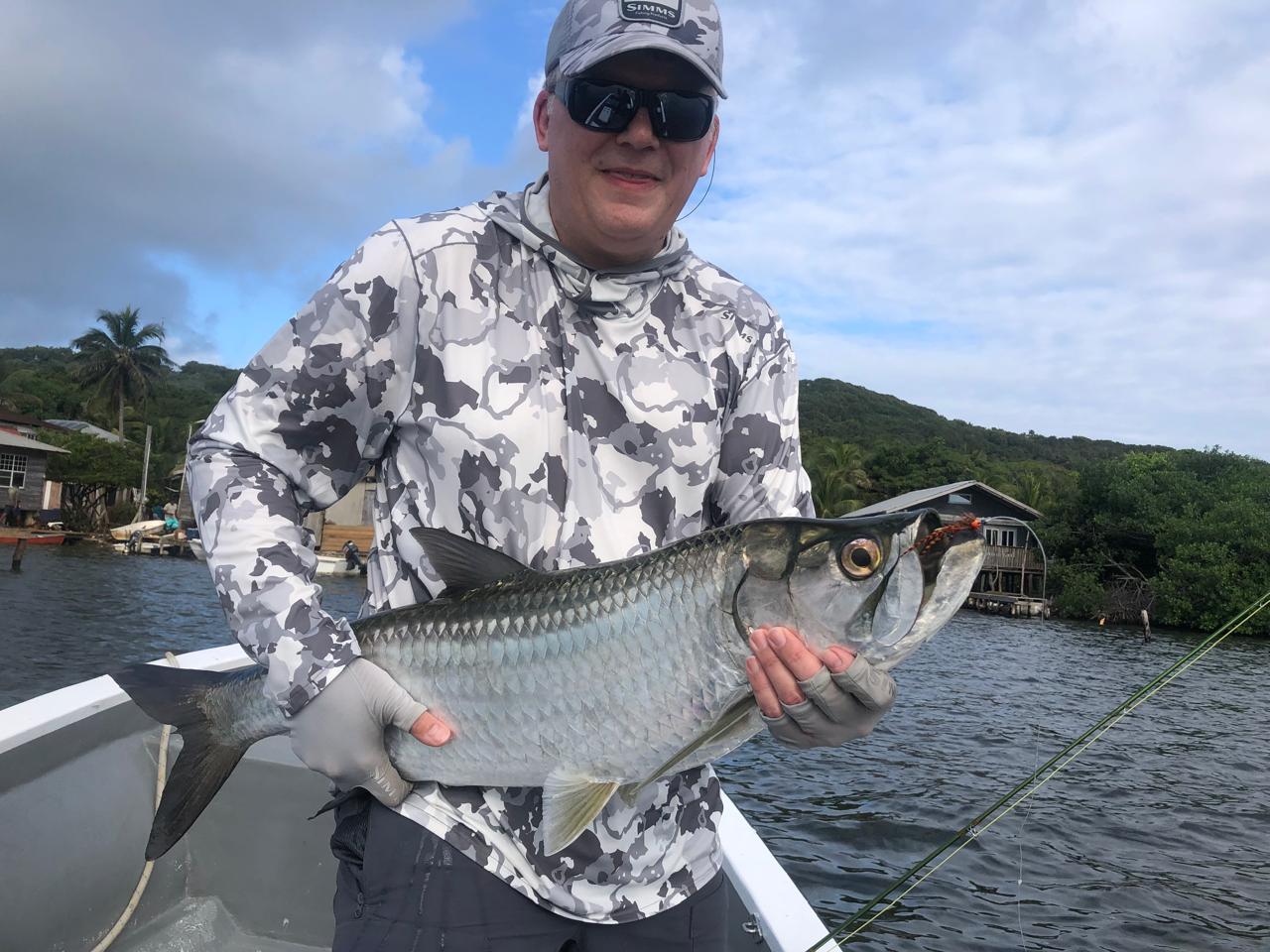 Angler holding a Roatan flats catch